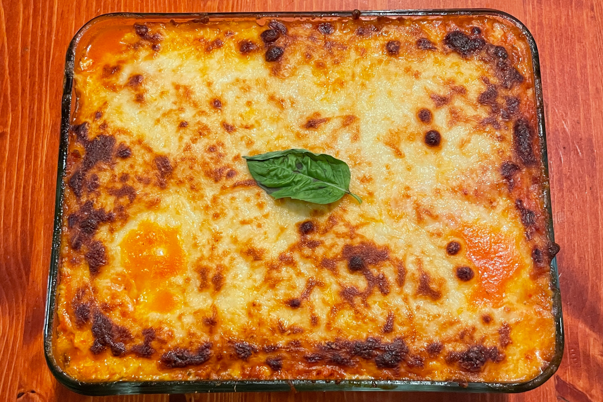 Top View of the baked pasta dish with a basil leaf in the middle